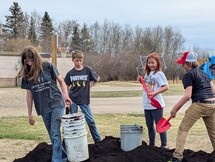Students hauling dirt to planters