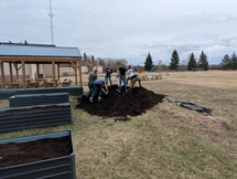 Students hauling dirt to planters
