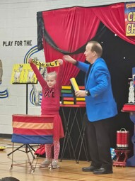 Steve Harmer doing a magic trick with a student